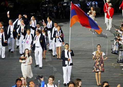 Arman Yeremian (Taekwondo), the flag bearer, and the Armenian delegation at the Opening Ceremony