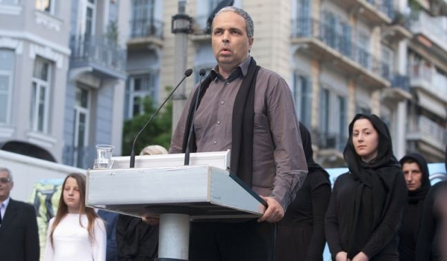 Ο Νίκος Λυγερός κατά τη διάρκεια της ομιλίας του στις εκδηλώσεις μνήμης για τη Γενοκτονία του Ποντιακού Ελληνισμού, το 2014, στη Θεσσαλονίκη (φωτ.: ΑΠΕ-ΜΠΕ/Σωτήρης Μπαρμπαρούσης)